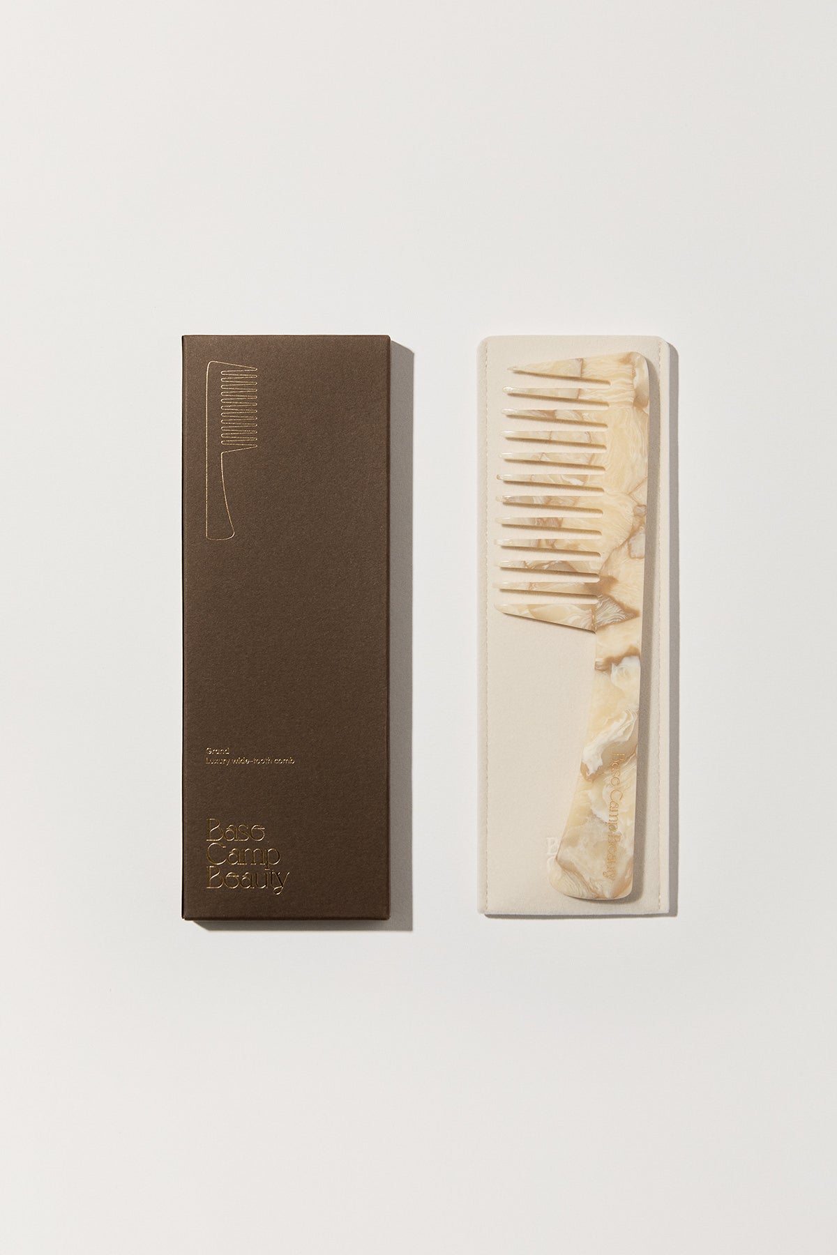 Base Camp Grand Comb: Buttermilk, a wide-tooth comb crafted from premium Acetate. Features flat teeth for volume and detangling. Measures 60mm x 213mm x 6mm.